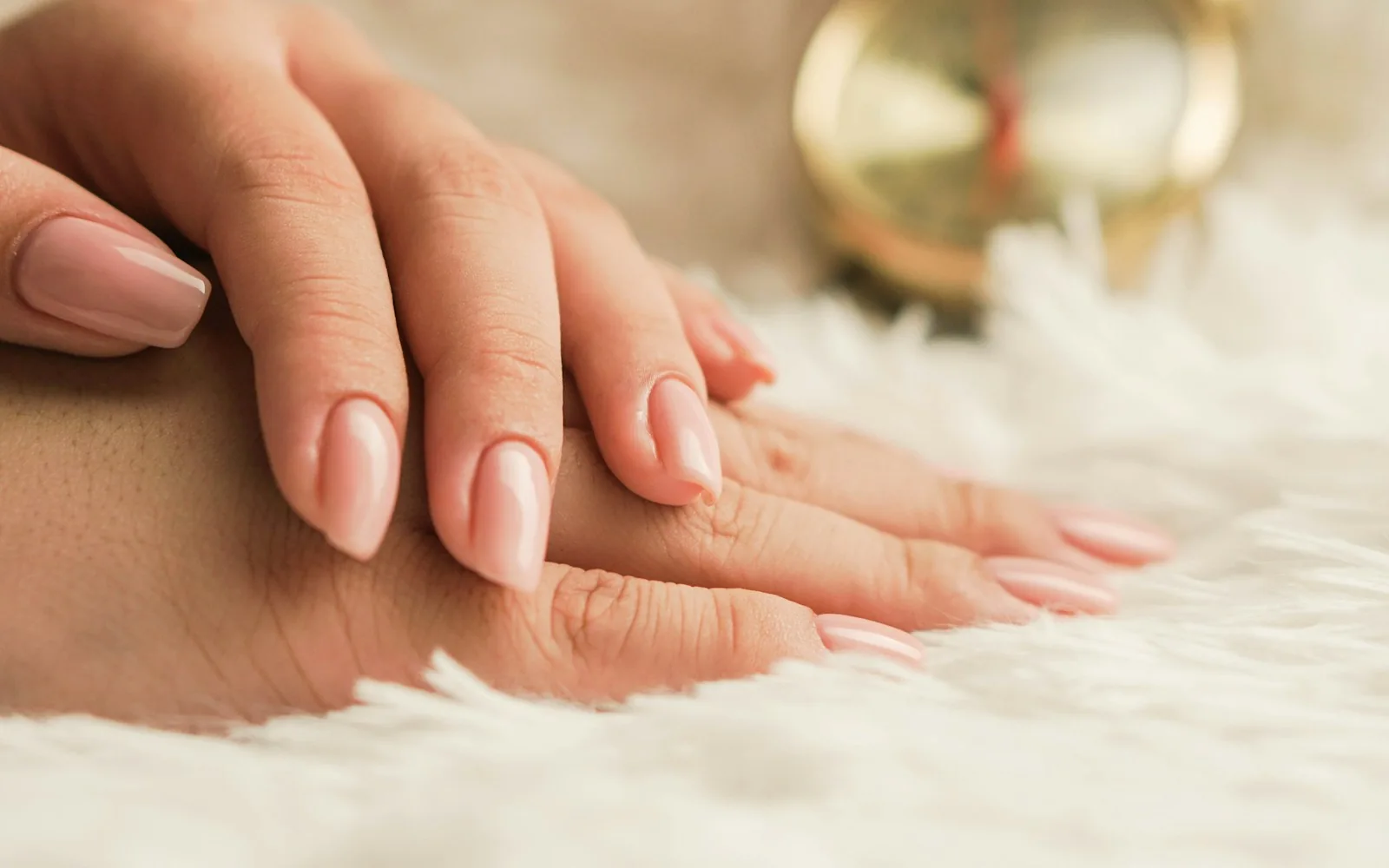 A nail artist carefully working on a natural manicure